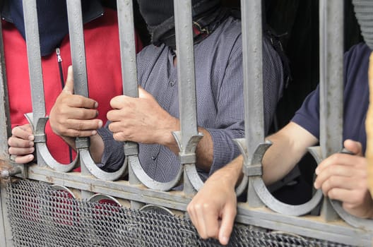 Workers barricaded behind bars for protesting the poor working conditions.