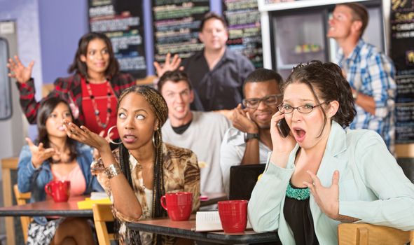 Group of people annoyed with obnoxious person on phone