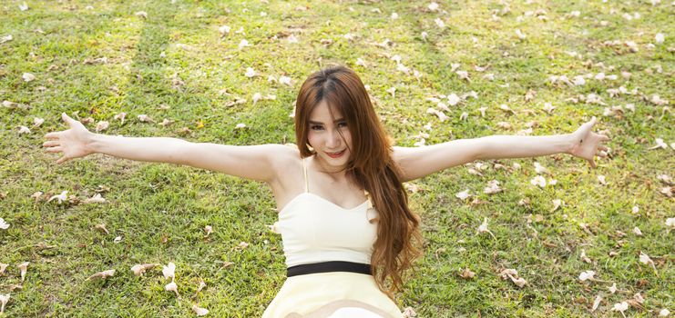 Young woman relaxing on the grass. Park in the warm sunshine.