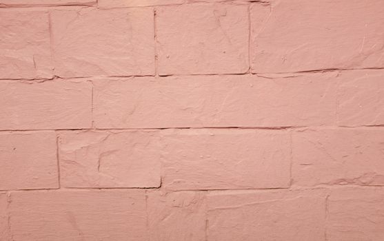 A pink painted rendered wall with embedded lines.