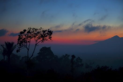 Misty sunset over the lush Balinese landscape