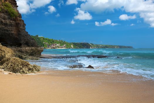 Surf waves and turqoise water along the coast of Bali