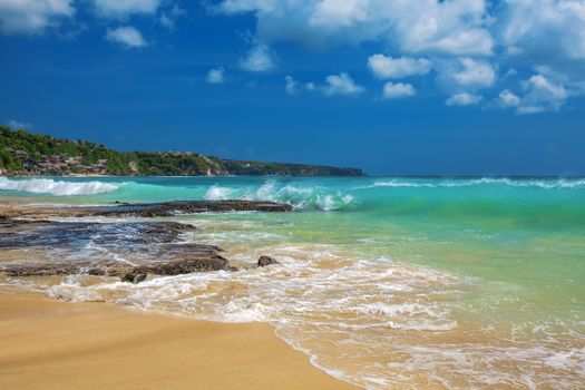 Surf waves and turqoise water along the coast of Bali