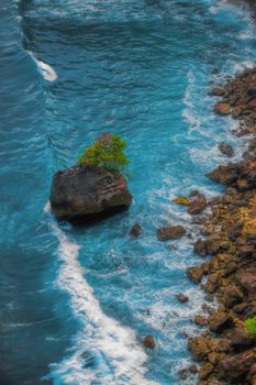 Surf waves and turqoise water along the coast of Bali