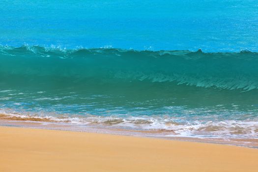 Surf waves and turqoise water along the coast of Bali