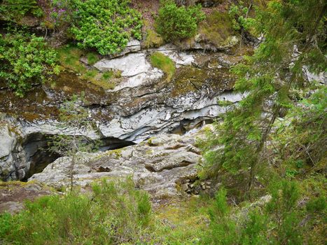 River deep in mountain forest. Nature composition.