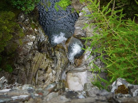 River deep in mountain forest. Nature composition.