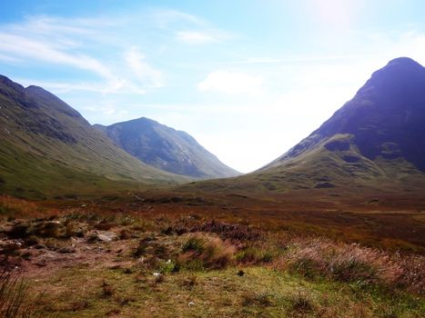 Scottish Highlands, mountain valley with blue sky