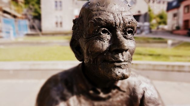 Bronze grandpa monument in Scotish Highlands in summer