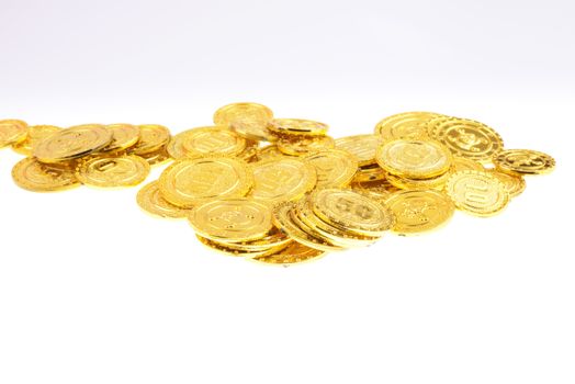 Pile of gold coins on a white background