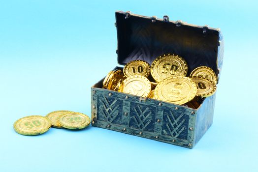 Treasure box with gold coins on a blue background