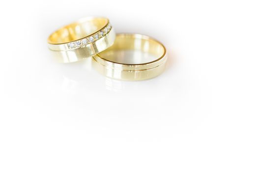 Wedding day details - two lovely golden wedding rings awaiting their moment, with some nice reflections