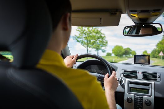 Man driving a car with his hands on the steering wheel