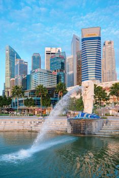 SINGAPORE -  JAN 01, 2014:  The Merlion fountain and Marina Bay on morning. Merlion is a mythical creature with the head of a lion and the body of a fish is a symbol of Singapore.
