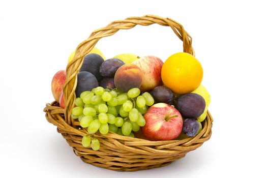 fresh fruits in a basket on white background