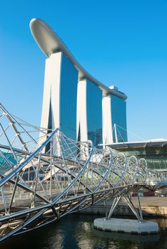 SINGAPORE - JUNE 01, 2013: Marina Bay Sands, an integrated resort and shopping mall with modern Helix bridge on front. 