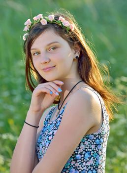 Portrait of beautiful girl with flower wreath in their hair, outdoor
