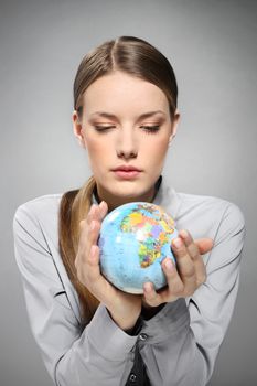 A woman holding a globe in his hands