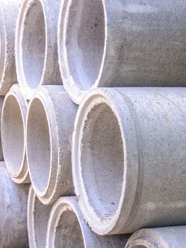 Concrete drainage pipes stacked on construction site