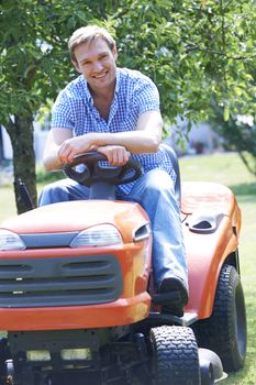 Man Cutting Grass Using Sit On Mower