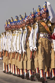 Soldiers in bright blue headdress parading down the Raj Path in preparation for the annual Republic Day Parade in New Delhi, India