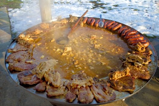 Traditional croatian dish - kotlovina plate cooking