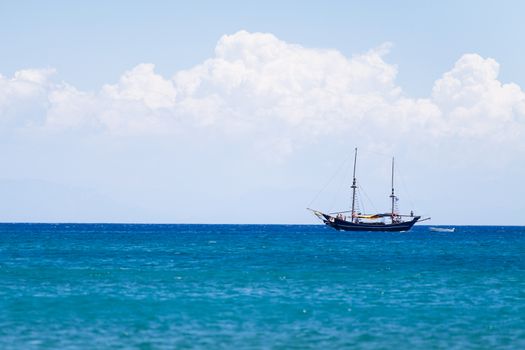 Lonely ship boat sailing near Rhode Island in Greece. Beautiful seascape background.