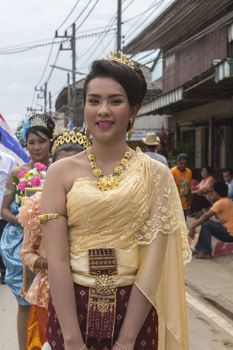 THAILAND - OCTOBER 20: Unidentified woman participated in "Ngan Chak Pra", a traditional buddhist festival on October 20, 2013 in Chaiya,Suratthani, Thailand.