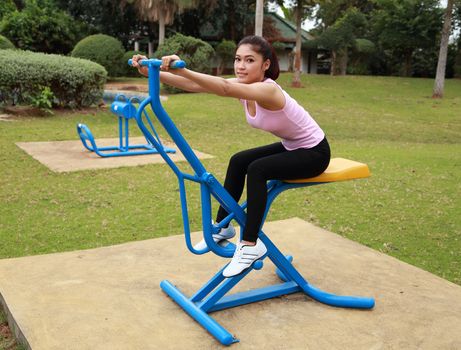 woman exercising with exercise equipment in the public park