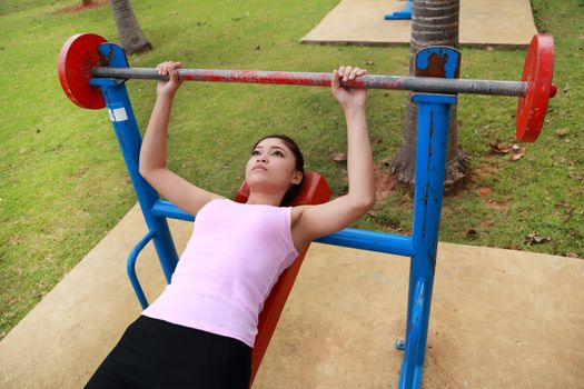 woman exercising with exercise equipment in the public park