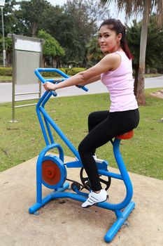 woman exercising with exercise equipment in the public park