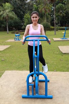 woman exercising with exercise equipment in the public park