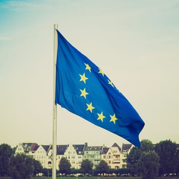 Vintage retro looking Flag of Europe over a blue sky