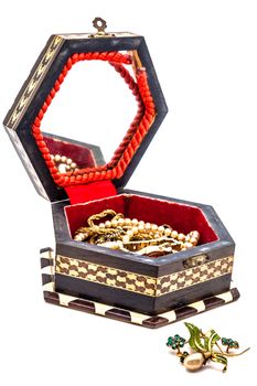 A composition of a vintage jewel box on a white background