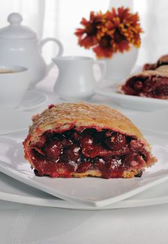 Piece of cherry strudel on the coffee table