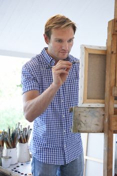 Male Artist Painting In Studio