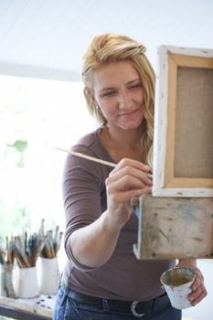 Female Artist Painting In Studio
