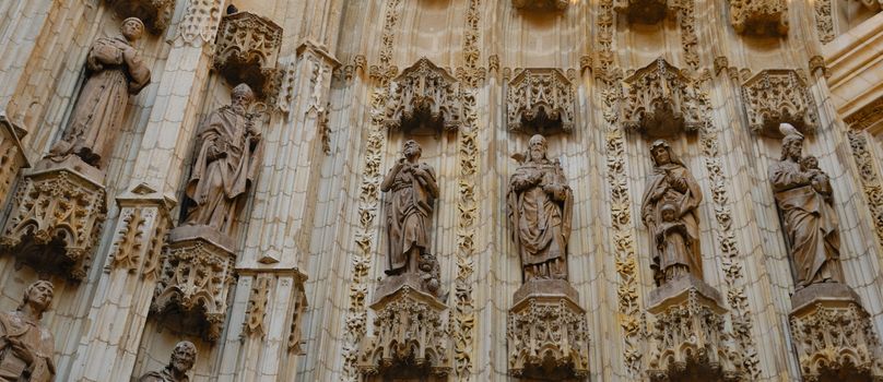 Detail of the door arch at the Cathedral of Saint Mary of the See, better known as Seville Cathedral in Seville (Andalusia, Spain). It is the largest Gothic cathedral and the third-largest church in the world.