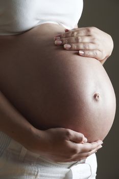 Low Key Image Of Pregnant Woman