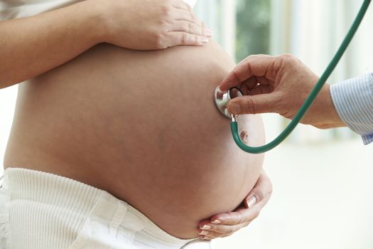 Doctor Giving Healthcheck To Pregnant Woman