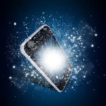 Smart phone with magic light and falling stars. Dark background