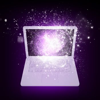 Open laptop with magic light and falling stars. Dark background