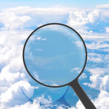 Magnifying glass looking sky in background. View from above the clouds