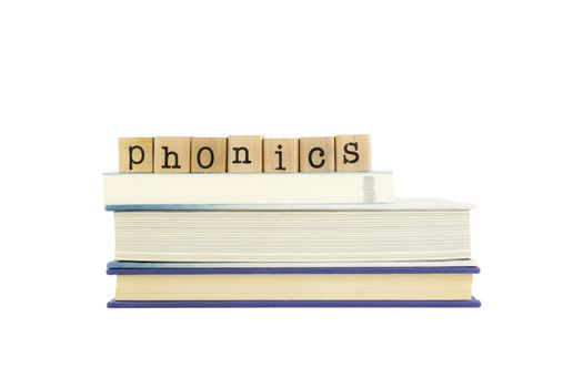 phonics word on wood stamps stack on books,  language and reading concepts
