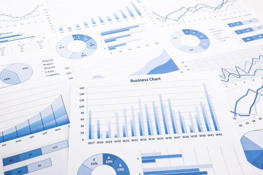 blue business charts, graphs, reports and paperwork for financial and business concepts