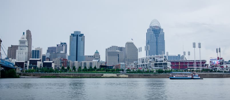 Cincinnati skyline and historic John A. Roebling suspension bridge cross Ohio River.