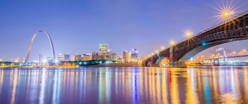 City of St. Louis skyline. Image of St. Louis downtown with Gateway Arch at twilight.