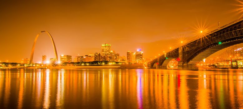 City of St. Louis skyline. Image of St. Louis downtown with Gateway Arch at twilight.