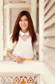 portrait woman smiles in traditional wood house