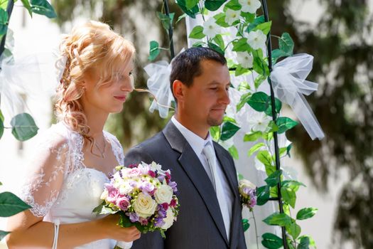 beautiful young wedding couple in park, blonde bride and her groom